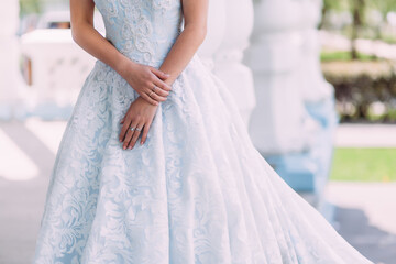 hands of a girl in a wedding blue dress