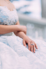 hands of a girl in a wedding blue dress