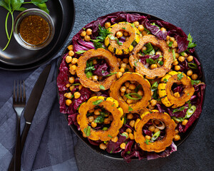 Plant based salad with Delicata squash, radicchio, and chickpeas; overhead view, copy space