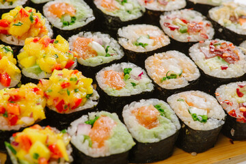 Maki Sushi Rolls set on wooden board. Japanese traditional Cuisine. White background.