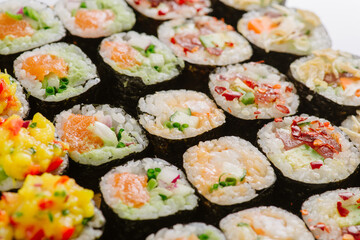Maki Sushi Rolls set on wooden board. Japanese traditional Cuisine. White background.