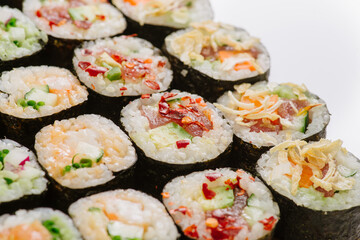 Maki Sushi Rolls set on wooden board. Japanese traditional Cuisine. White background.