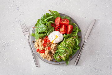 quinoa with poached egg, avocado tomato salad leaves. healthy vegetarian lunch breakfast