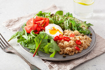 quinoa with poached egg, avocado tomato salad leaves. healthy vegetarian lunch breakfast