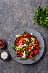 healthy colorful tomato mozzarella basil salad with balsamic vinegar dressing