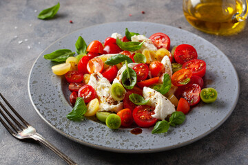 healthy colorful tomato mozzarella basil salad with balsamic vinegar dressing