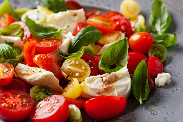 healthy colorful tomato mozzarella basil salad with balsamic vinegar dressing