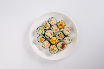 Maki Sushi Rolls set on wooden board. Japanese traditional Cuisine. White background.
