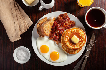 traditional full american breakfast eggs pancakes with bacon and toast