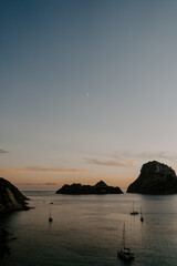 A relaxing scene of a small rocky island Es Vedra at sunset in Ibiza.