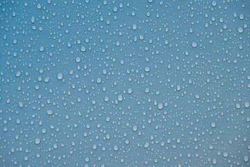 Fototapeta premium Raindrops on blue plastic film