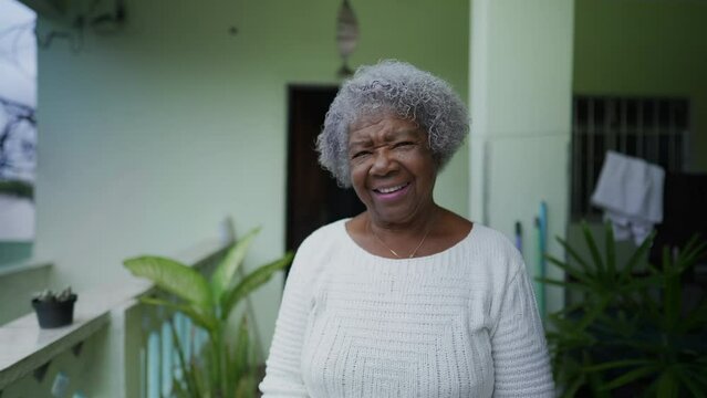 A Brazilian senior lady portrait standing outside smiling at camera