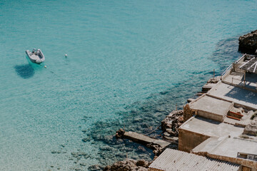 A tranquil scene of beautiful landscape in Ibiza overlooking turquoise waters and white sand beach.