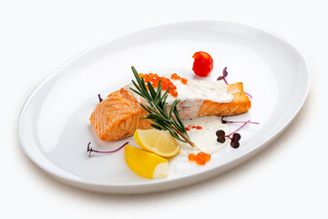 Salmon fillet with sauce and red caviar, rosemary and lemon.