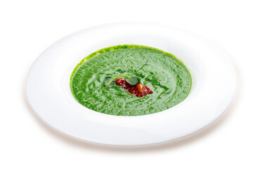 Broccoli cream soup and green peas on a white plate