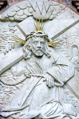 Three-dimensional painting of jesus made of white stone. Religious statue.