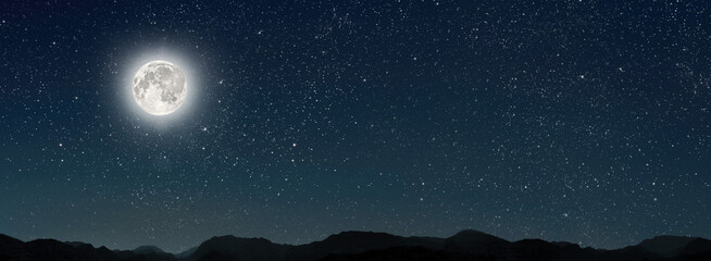 month on a background stars the sky shines over the mountains