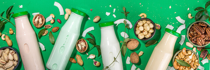 keto, paleo and vegan diet concept. Set of nut milks, bottles with various non-dairy nut milk -...