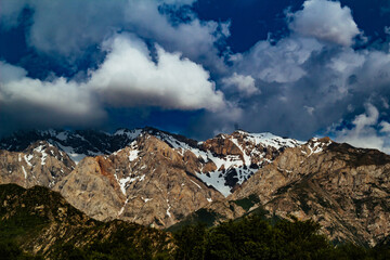 amazing mountain peaks under blue sky and clouds