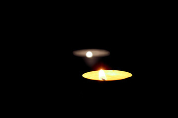 Two burning candles on the table in honor of the commemoration in the dark