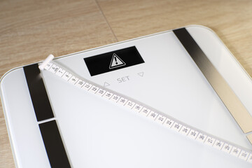 A closeup shot of a scale and a measuring tape