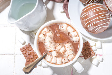 Homemade hot chocolate bomb with marshmallow and chocolates and nuts, Cooking making cocoa with chocolate ball, dropping coca bomb in milk