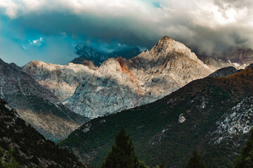 amazing mountain peaks under blue sky and clouds