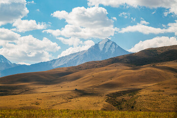 amazing mountain peaks under blue sky and clouds