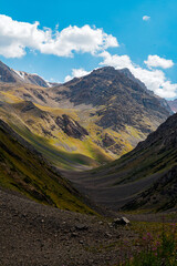 mountain gorge under sky with clouds