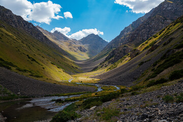 mountain gorge under sky with clouds