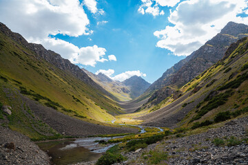 mountain gorge under sky with clouds