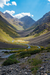 mountain gorge under sky with clouds