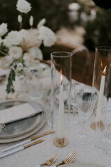 Elegant destination wedding table setting featuring a neutral color palette fine tableware floral arrangements and personalized menus. A perfect image for luxury events, receptions, and celebrations
