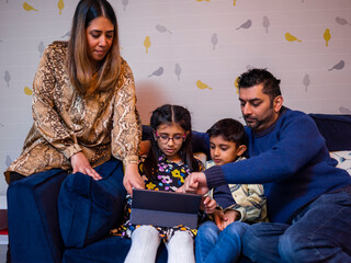 Parents and children using digital tablet