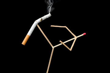Quit Smoking Concept - match man kicks off a cigarette over black background
