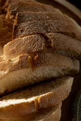 Close up view of sliced white bread on rustic wooden table