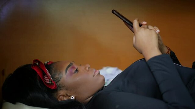 A teenger girl using cellphone on in bedroom