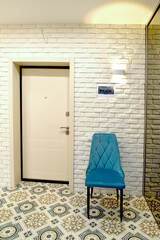 Fragment of the interior of the corridor with an upholstered chair