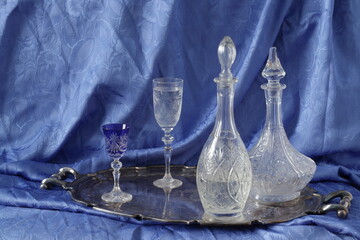 Still life with decanters and a glasses on a silver tray