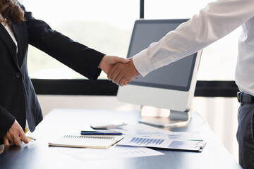 Businesspeople in the office handshake.