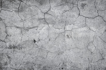 Gray cracked stucco, concrete and cement wall pattern. Asymmetric and abstract broken on textured Background.