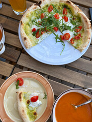 pesto pizza with arugula and cherry tomatoes