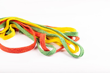 colored laces or accessories used in the manufacture of textiles, standing on a silver background. Ropes standing on white background. textile accessories. colored laces.