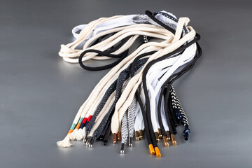 colored laces or accessories used in the manufacture of textiles, standing on a silver background....