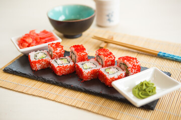 Maki roll with salmon, popular Japanese cuisine. Sushi roll with fish, cream cheese and vegetables