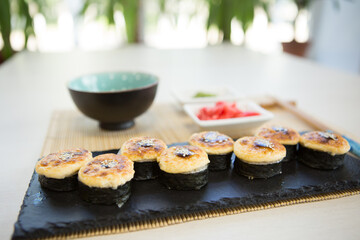 Maki roll with salmon, popular Japanese cuisine. Sushi roll with fish, cream cheese and vegetables