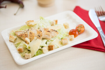 Homemade Vegetable salad on a plate on wooden cutting board