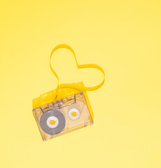 Cassette tape close up, blank for customisation of label, isolated and presented in yellow...