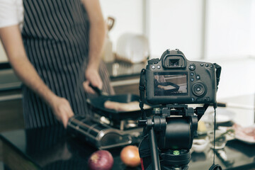 Close up of a video camera filming.