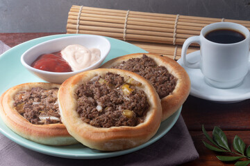 Delicious and traditional meat sfiha with black coffee.